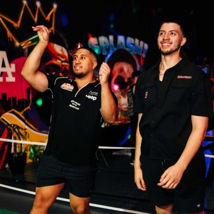 Happy staff enjoying their work function playing basketball